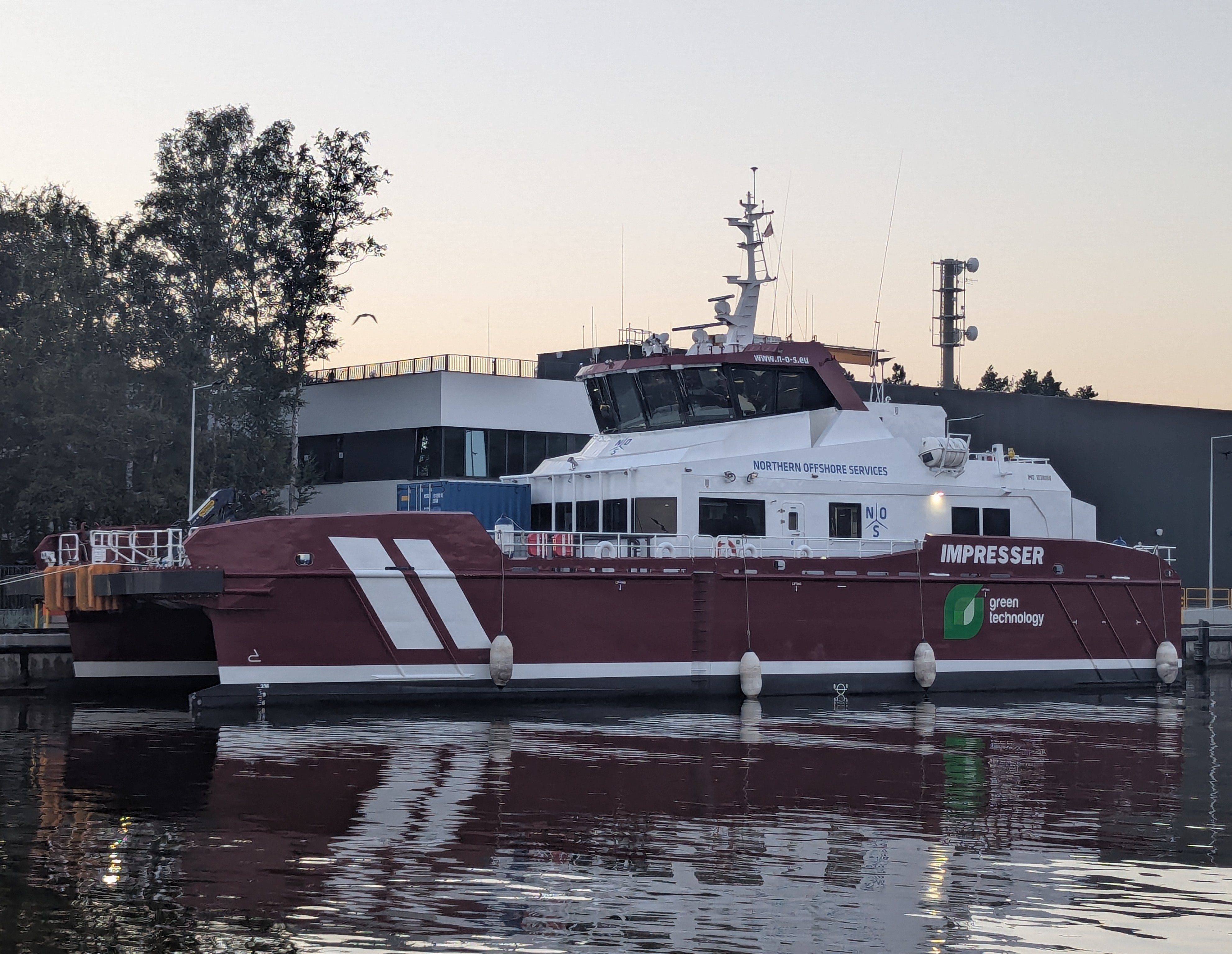 Crew transfer vessel moored at dusk